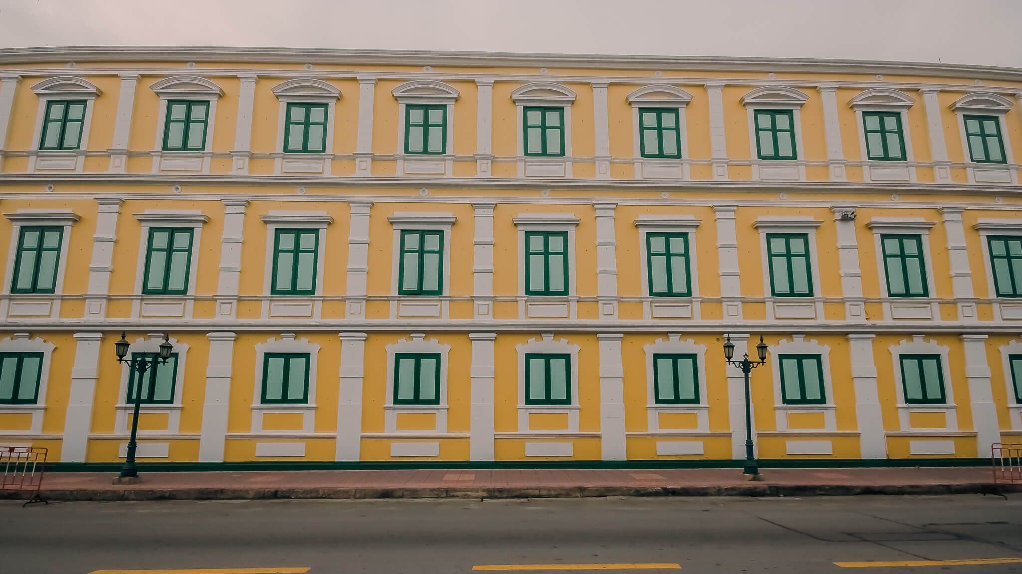 Yellow building wall with green window