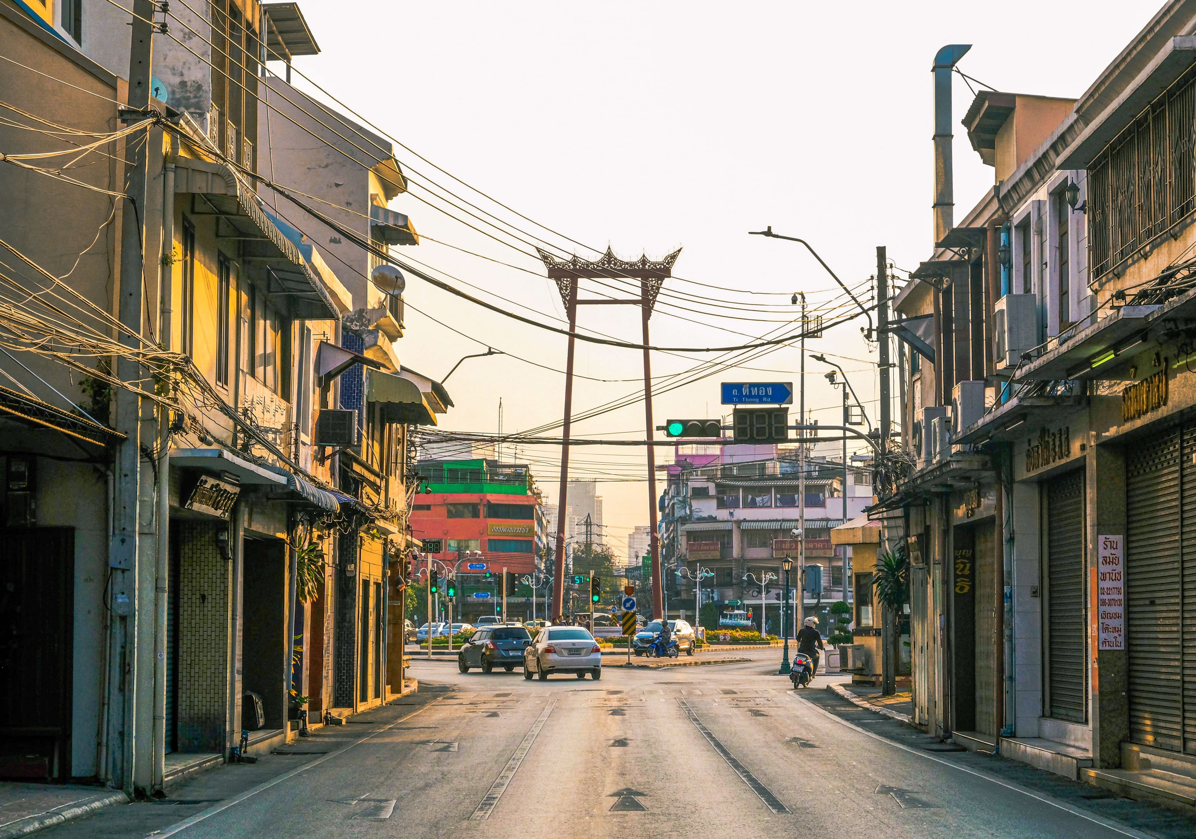 A morning scene in Thailand with temples, an old town, and everyday life unfolding alongside time.