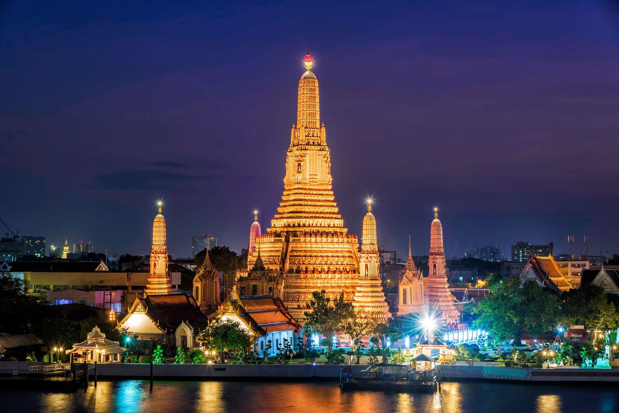Wat Arun beside the Chao Phraya River at sunset